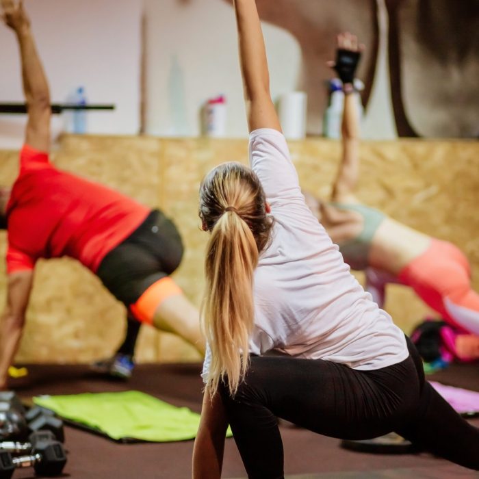 hiit interval training. High intensity interval training group indoors. Group fitness training. Back view.